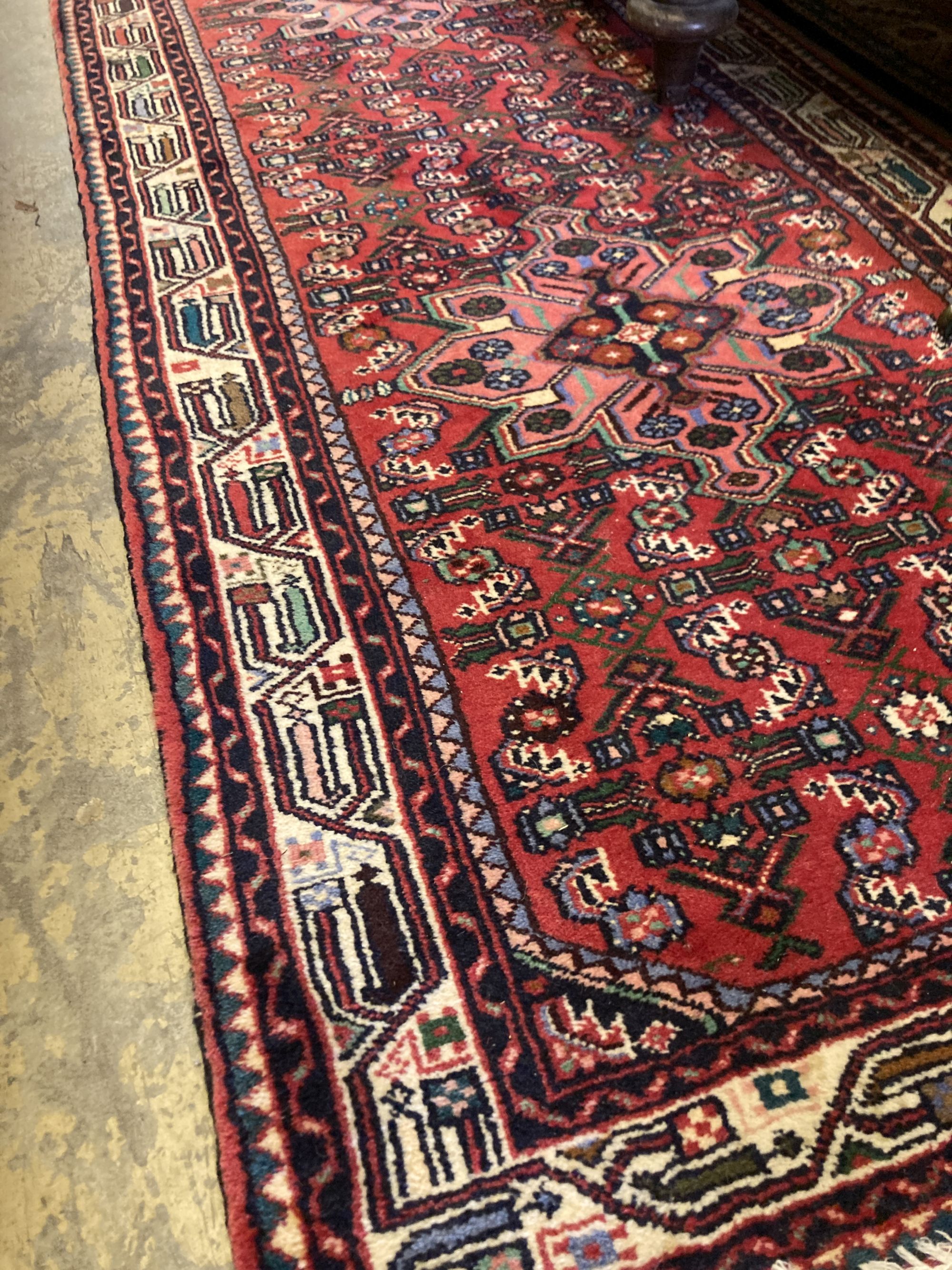 A Caucasian design red ground runner, 310 x 86cm
